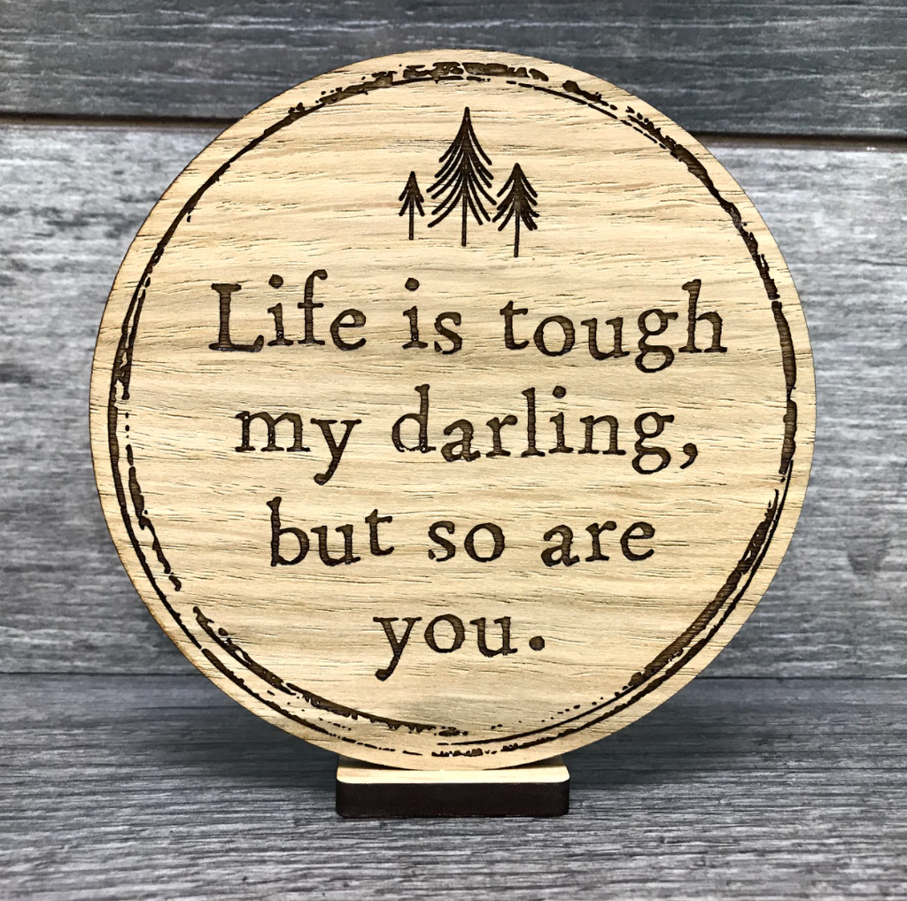 Engraved oak wooden disc saying Life is tough my darling, but so are you. 
