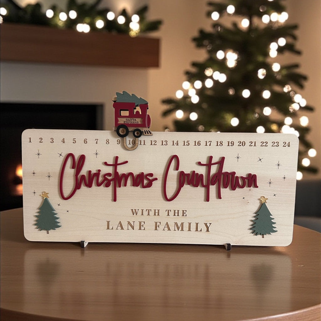 Christmas countdown calendar on a table with a decorated tree in the background