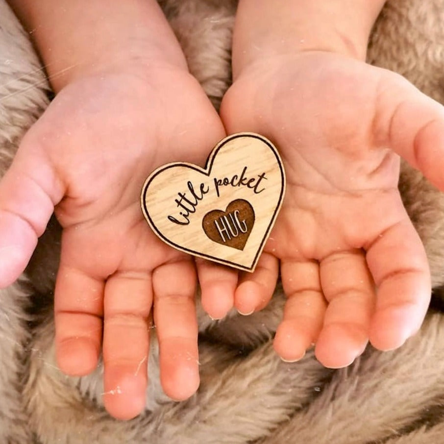 Wooden oak heart shaped token in child's hand - gift item